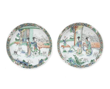 A pair of famille verte 'ladies' dishesKangxi Each finely enamelled with a central scene of two court ladies standing at a te