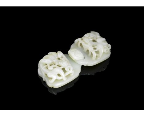 A large pale jade 'chilong' double buckle18th centuryEach section of bracket-lobed form, carved in high openwork relief with 