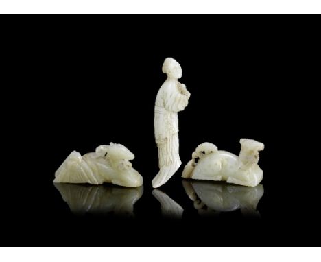 A group of three pale green jade carvingsMing DynastyComprising: a figure of a recumbent deer holding a bamboo sprig in its m