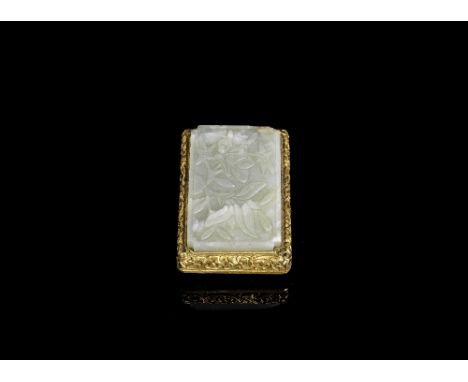 A jade mounted gilt-metal buckleQing DynastyThe jade plaque of pale green tone, carved with a stylised peony and leafy stems.