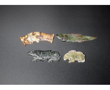 A group of four archaic zoomorphic plaquesWestern Zhou Dynasty and possibly laterComprising: a creamy jade leaping fish, with