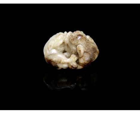 A white and mottled brown jade 'Buddhist lion' group17th century or laterThe recumbent beasts curled around and with their co