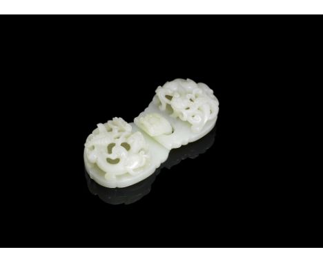A pale green jade 'chilong' double buckle18th centuryEach lobed section carved in openwork relief with a striding coiled chil