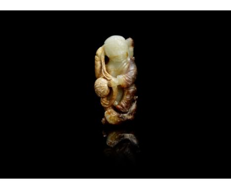 A pale green and russet jade 'foreigner and lion' groupQing DynastyThe figure standing with one foot resting on a playful lio