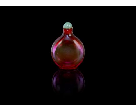 A pale ruby glass snuff bottle1720-1780, attributed to the Palace workshops, BeijingOf compressed rounded form, resting on a 