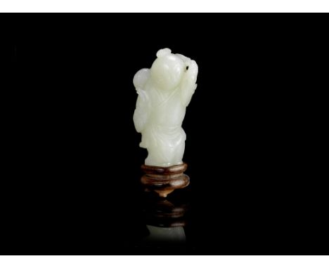 A pale green jade carving of a boy18th centuryThe smiling figure with the head turned to his right, holding a brocade ball on