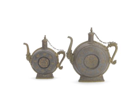 Two gold, silver and copper damascened iron ewersTibet, 17th-19th centuryEach with makara-head spout and dragon handle flanki