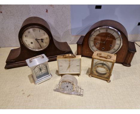 A selection of mantle clocks including manual wind and later electric examples. 