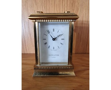 Mappin &amp; Webb, a quartz presentation brass carriage time piece, the enamel dial signed, 12 cm, box 