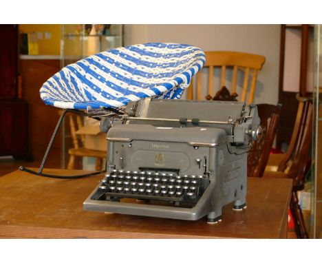 A mid-20th century child's rocking chair, together with a Imperial typewriter (2) 