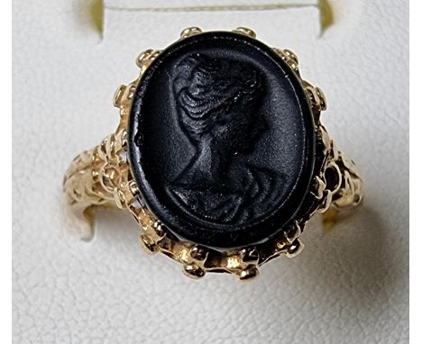 A 9ct gold a black glass cameo ring, size O, 4.3 gms 