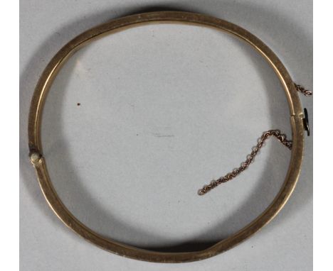 A 9ct gold hollow bangle, with engraved front, 10 gms. 