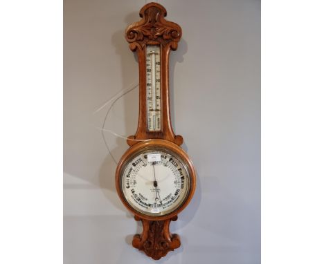 An oak wheell barometer, retailed by A. Pechy. Ipswich, with carved case, 80 cm. 