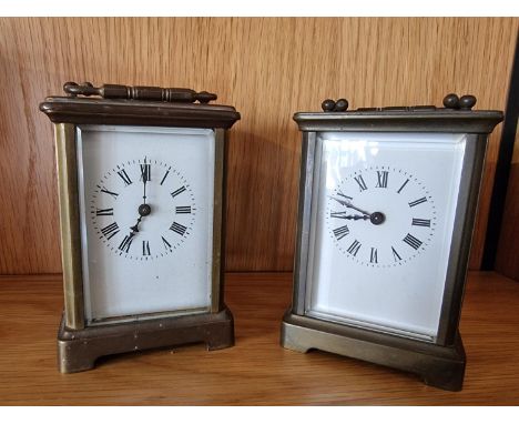 A brass carriage time piece, with white enamel dial, 11 cm and another similar 