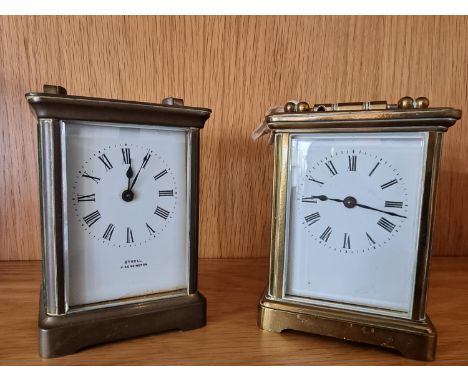A brass carriage time piece, with white enamel dial, signed Styrell, Kensington11 cm and another similar 