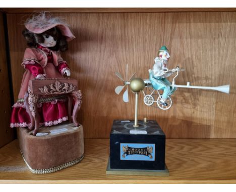 A mid-20th century antique style musical automaton in the form of a young girl playing the piano, clothed in Victorian style 