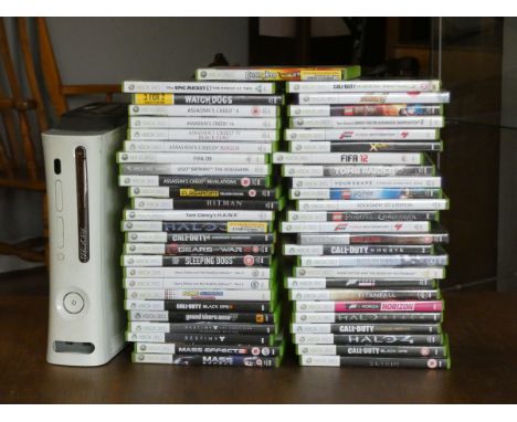 An XBOX 360 console complete with games, controllers, headphones and cables. 