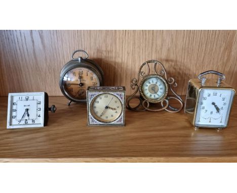 A brass and enamel desk time piece, with polychrome enamel decoration, 7 cm and four other clocks. 