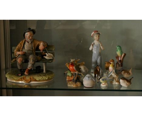 A Capodimonte ceramic model of a man feeding birds, together with Beswick horses, Royal Crown Derby ceramic robin and other c