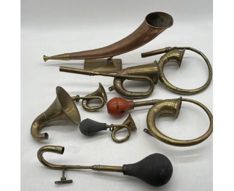An assortment of vintage brass car horns etc