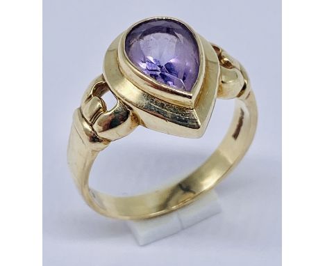 A 9ct gold ring set with a teardrop shaped amethyst, size P