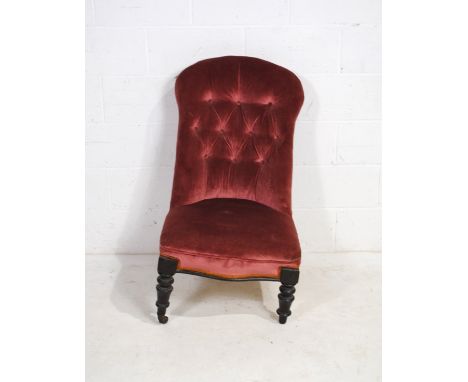A Victorian upholstered nursing chair, with button-back detailing, raised on turned legs - one castor missing 
