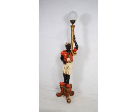 A painted and gilded wooden standard lamp in the form of a Blackmoore figure, holding a light with replacement globe shade - 