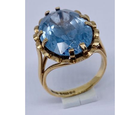 A 9ct gold ring set with a large blue stone, size M