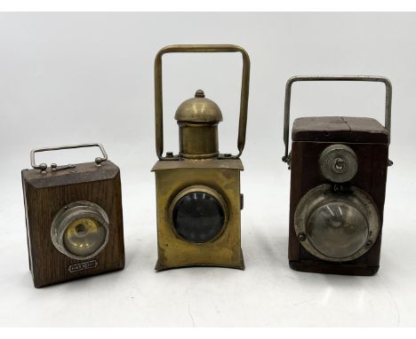 Two WW2 era Ever Ready wooden cased lamps along with a brass railway lamp
