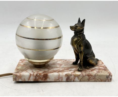 An Art Deco lamp with seated dog and globular shade on marble base