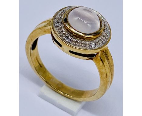 A moonstone and diamond cluster ring set in 9ct gold, size N