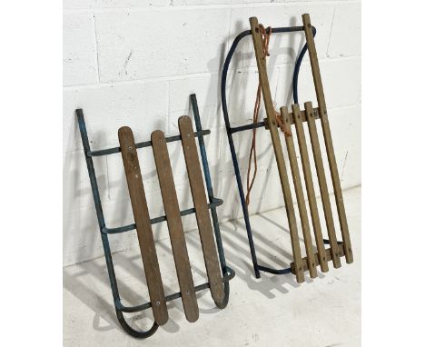 Two vintage sledges/toboggans with wooden seat on metal runners 