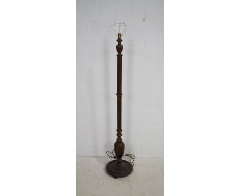 An antique oak standard lamp, with reeded detailing