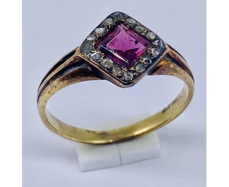 An antique garnet and diamond cluster ring set in unmarked 9ct gold, size J