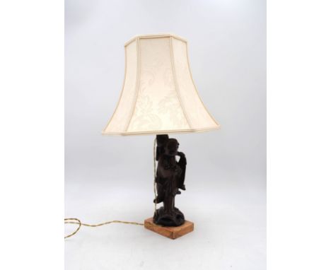 A Chinese table lamp, in the form of a carved wooden elderly man, on marble base, with shade