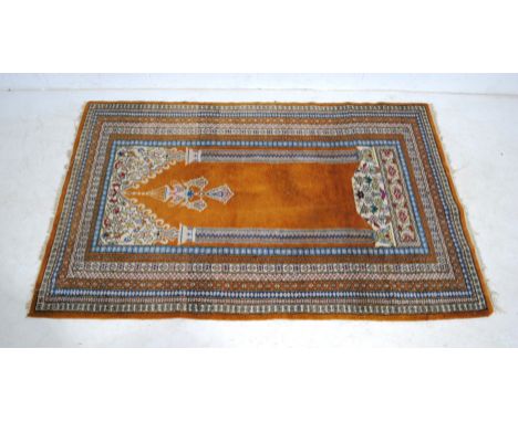An Eastern light brown ground prayer rug - 150cm x 96cm