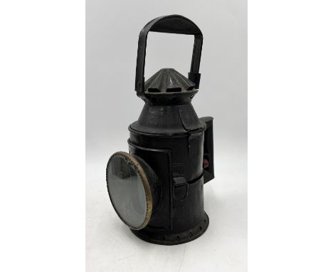 A vintage railway signal lamp with changeable green and red glass