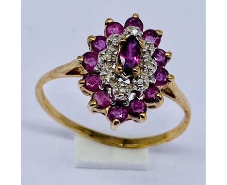 A ruby and diamond cluster ring set in 9ct gold, size R