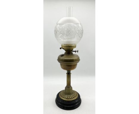 An early 20th century oil lamp with globular shade on ceramic base 