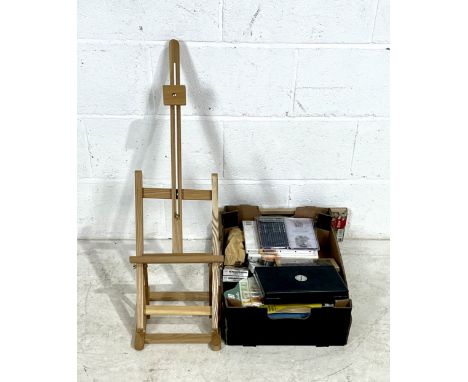 A desk top easel along with a selection of art materials chalks, pencils, sketch pads, canvases, brushes etc