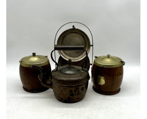 A vintage copper kettle, two biscuit barrels and a two-tier folding metal cake stand