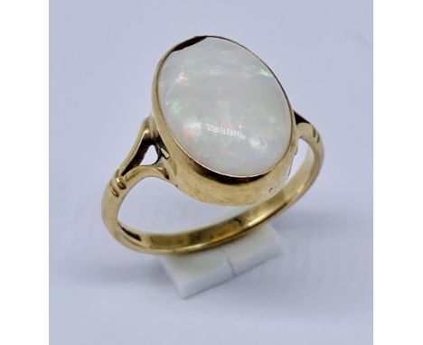An opal ring set in 9ct gold- chip to stone