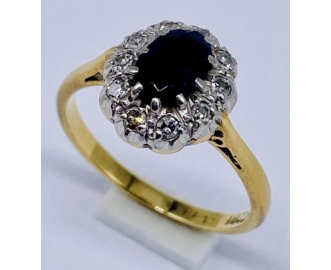 An 18ct gold and platinum diamond and sapphire cluster ring, size L 1/2