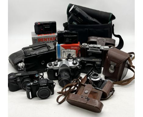 A collection of various vintage cameras including Pentax PC35, Pentax Asahi Spotmatic, Prontor II, Ferrania etc. 