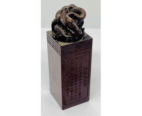 A Chinese hardstone seal of rectangular form surmounted with a coiled snake, inscription to one face and character marks to u