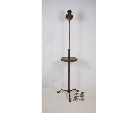 An antique adjustable brass standard oil lamp, with integral table, raised on tripod base - some parts loose but present