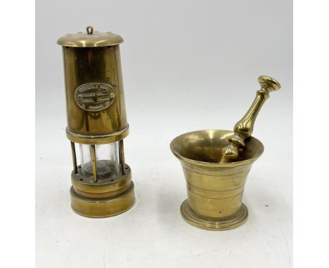 A brass miner's lamp named to Ferndale Coal along with a brass pestle and mortar