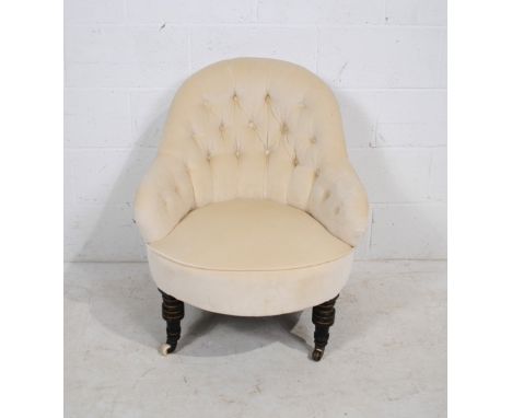 A Victorian upholstered nursing chair, with button-back detailing, raised on ebonised turned legs with gilded detailing