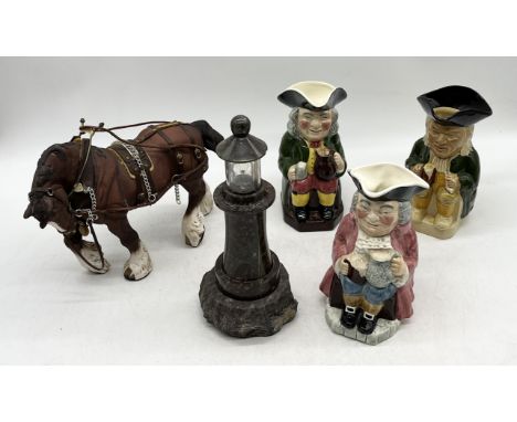 A collection of three Toby jugs, Beswick shire and serpentine lighthouse lamp 