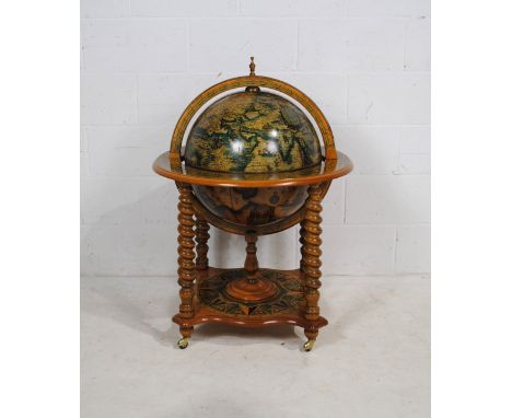 A reproduction drinks globe, raised on barley-twist supports - diameter 70cm, height 100cm